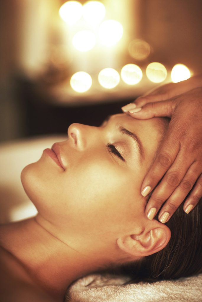 Let relaxation take over. Closeup shot of a young woman enjoying a head massage at the spa.